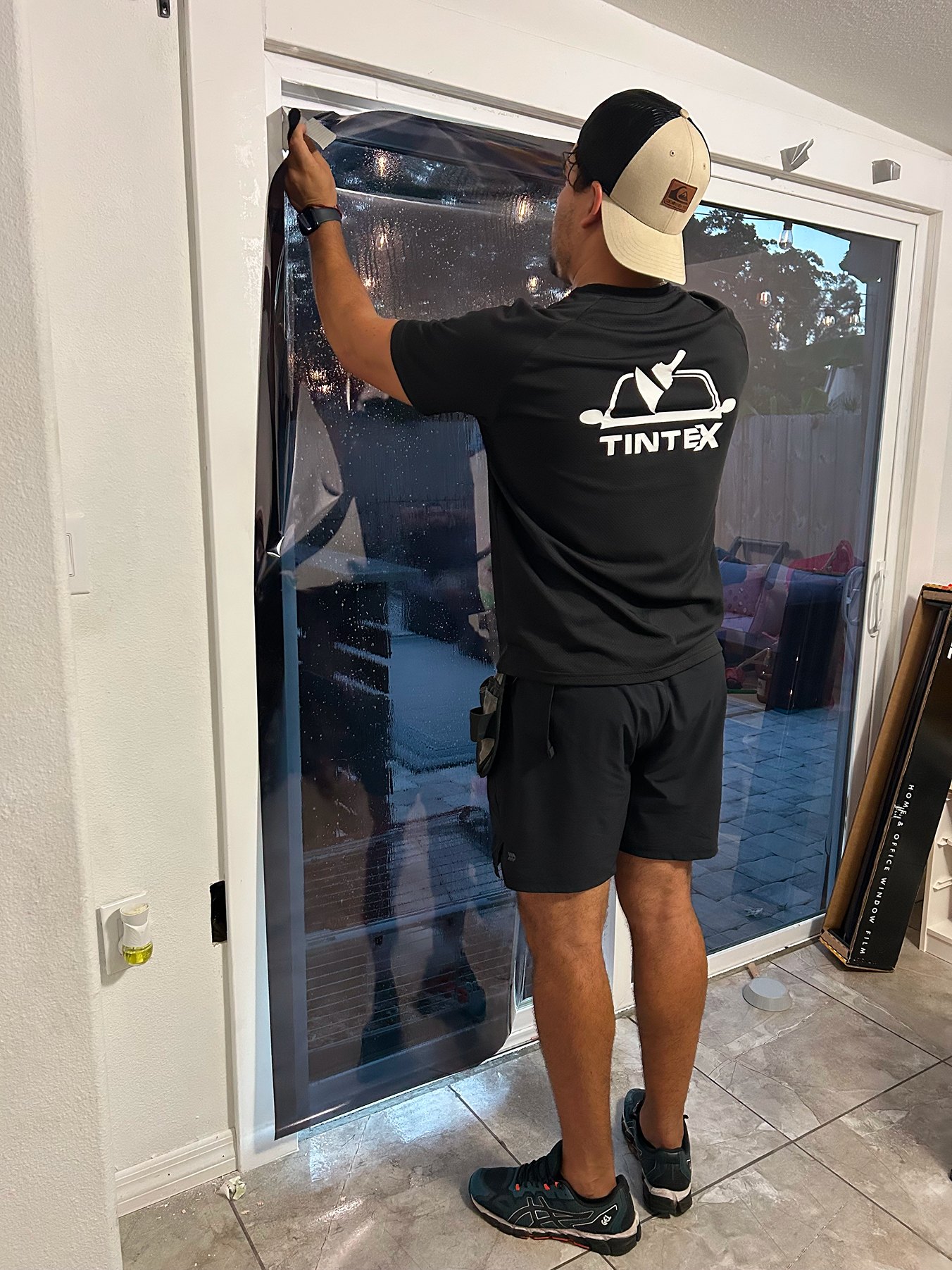 TINTEX installer applying residential window film